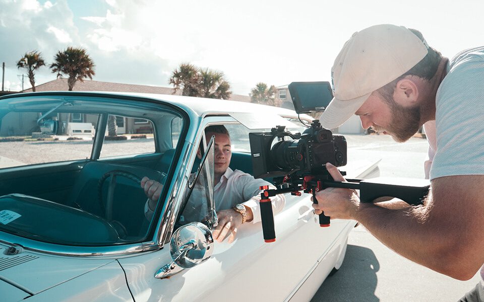 A Man Shooting With Camera Inside the Car