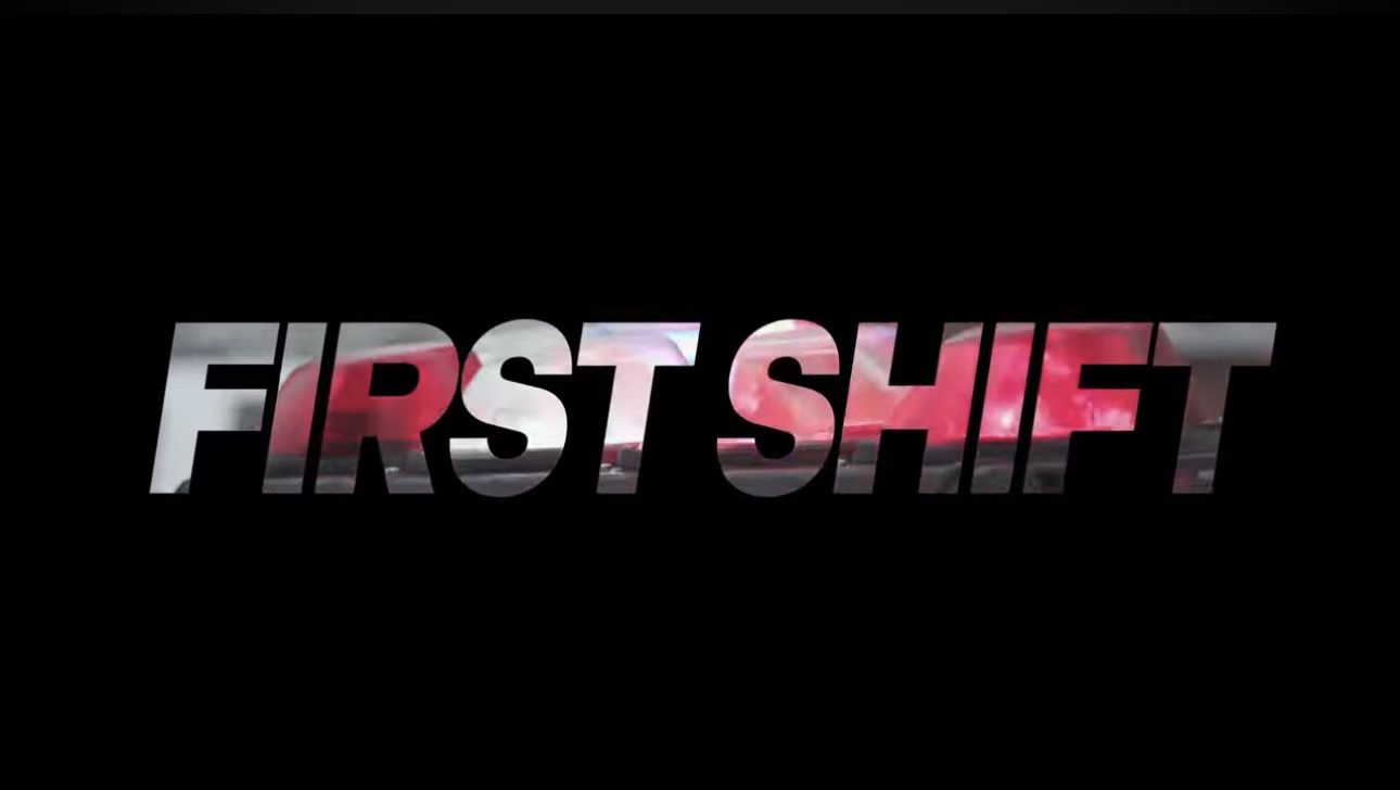 The logo of first shift with shades of red and gray and with a black background